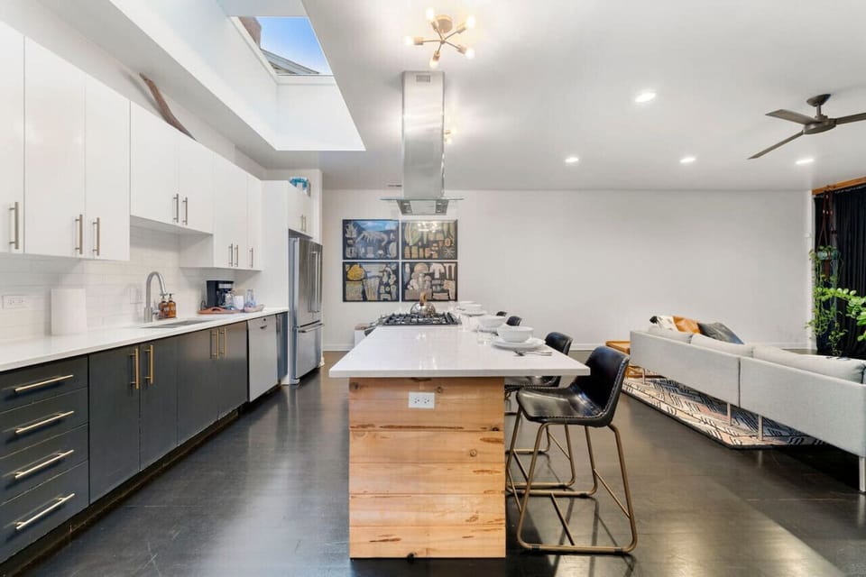 Bask in the sun-drenched kitchen, featuring a spacious 12-foot island, a top-notch gas stove, and crowned by a generous skylight. A culinary haven where natural light and modern amenities converge for a delightful cooking and dining experience