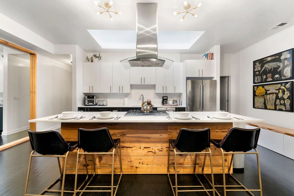 12’ island. Amazing to cook, work, or eat at under the natural light of the skylight. Outlets conveniently located on each side of the island for laptops, and views of clouds and even the moon can be enjoyed here, just look up!