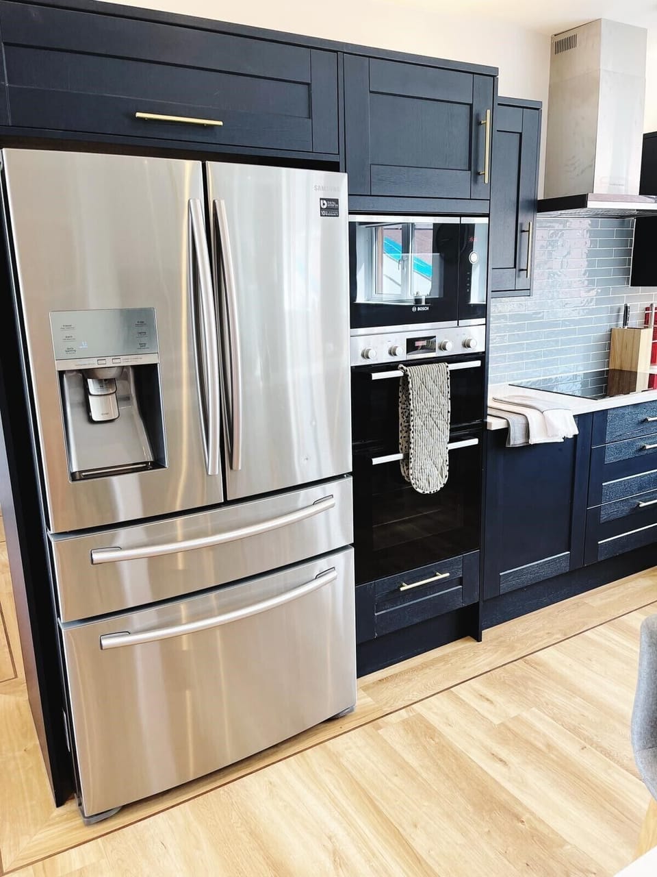 Stylish kitchen, modern fridge freezer, induction cooker and boiling water tap