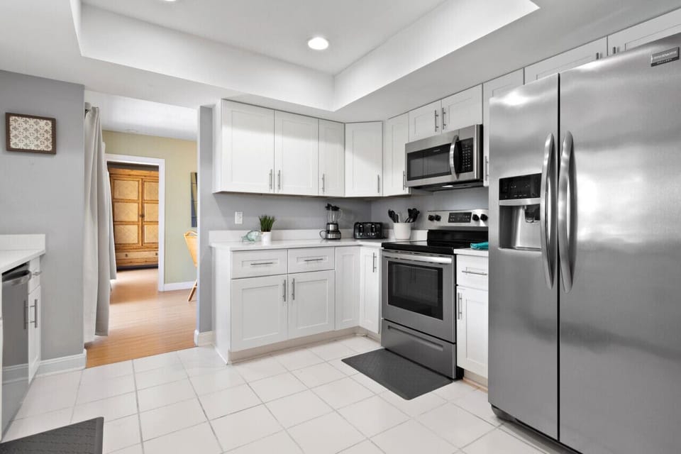 Prepare meals with ease in the bright kitchen featuring updated appliances and ample storage.