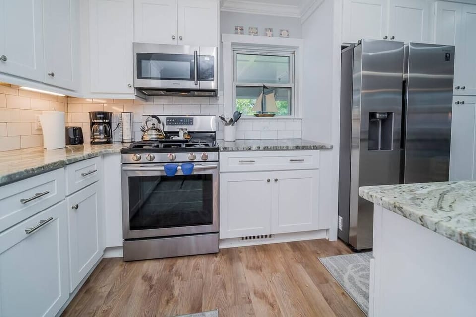 Brand new modern appliances in fully-stocked kitchen.