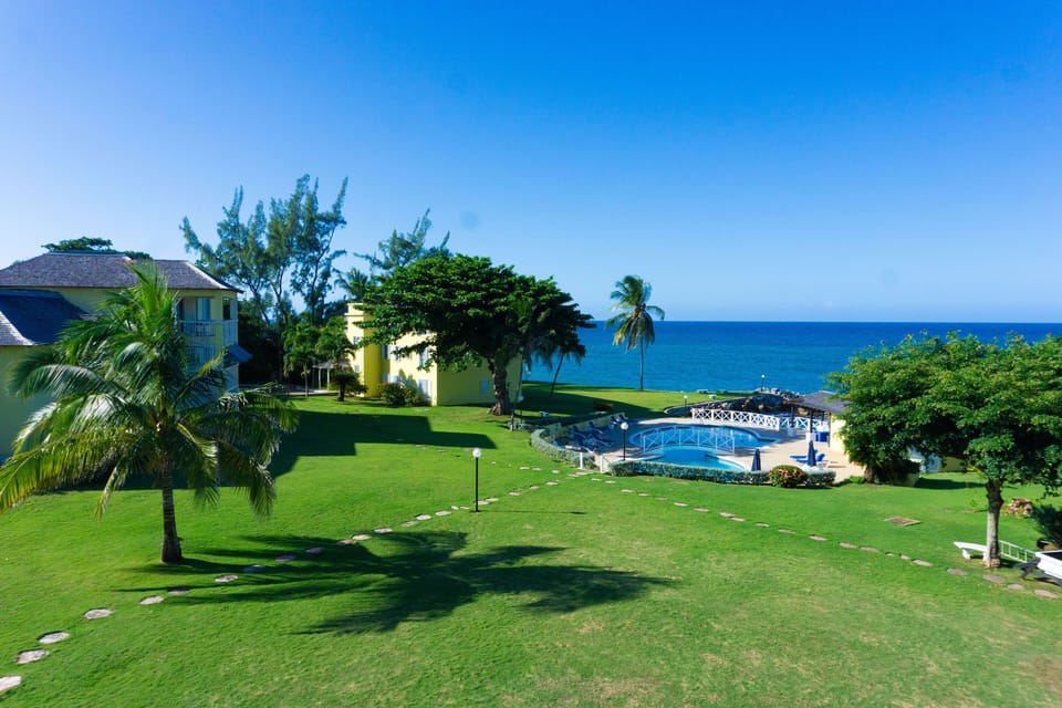 Paved walkway to pool and beach from Apartment blocks