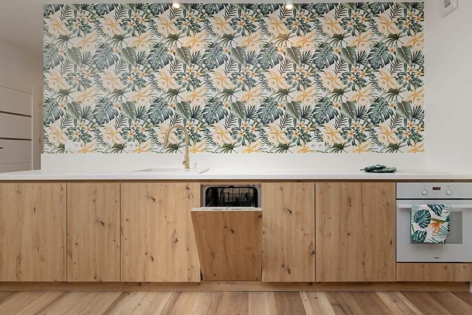 Fully equipped kitchen with wooden cabinets, a built-in dishwasher, and all the essentials for home cooking.