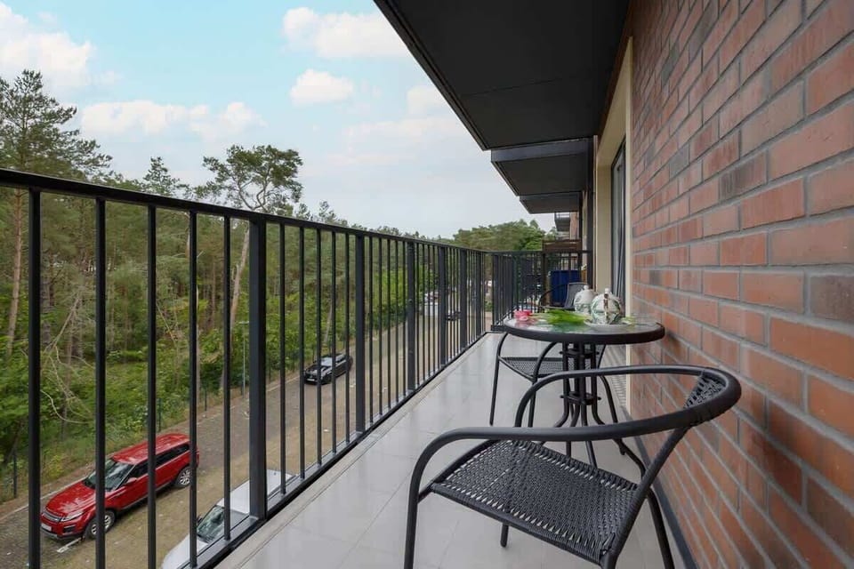 Private balcony with outdoor furniture, ideal for morning coffee or sunset relaxation.