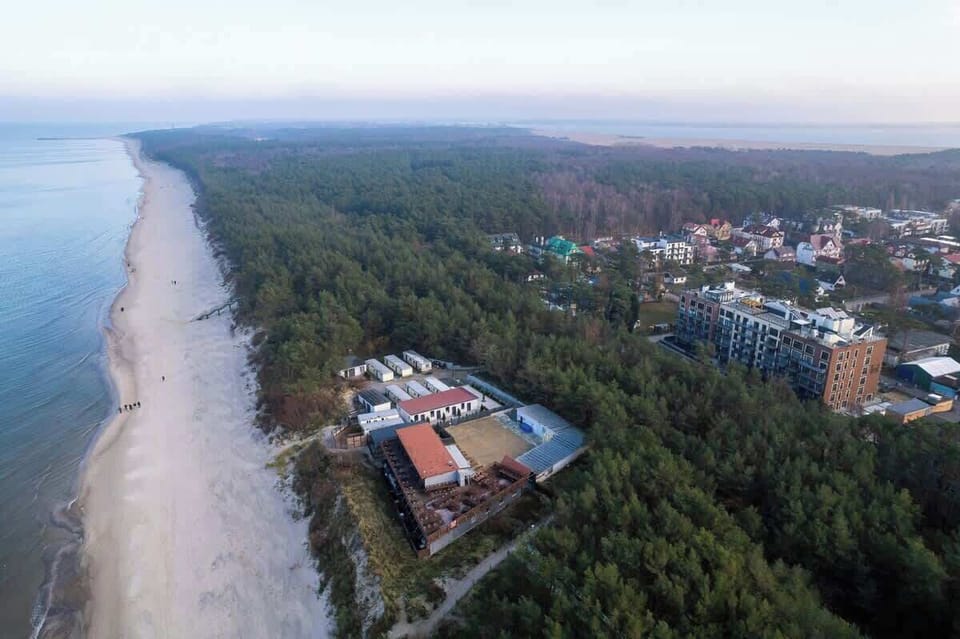 Aerial neighborhood view showing the apartment’s perfect seaside location and peaceful surroundings.