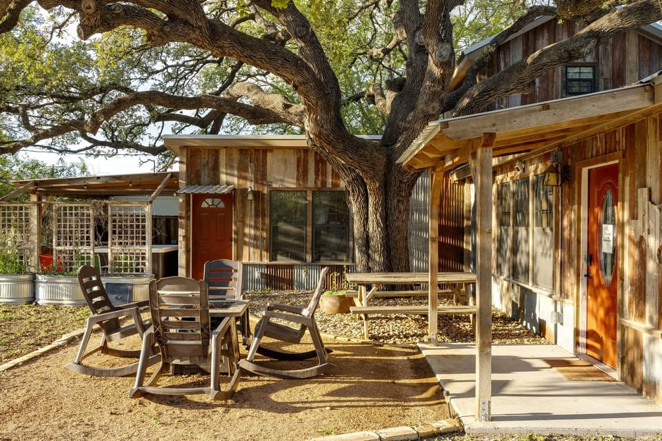 Relax under the sprawling branches of our ancient oak tree, a favorite spot for guests to enjoy the fresh Hill Country air. The private patio features comfortable rockers and a picnic table, making it the perfect home base for your group.