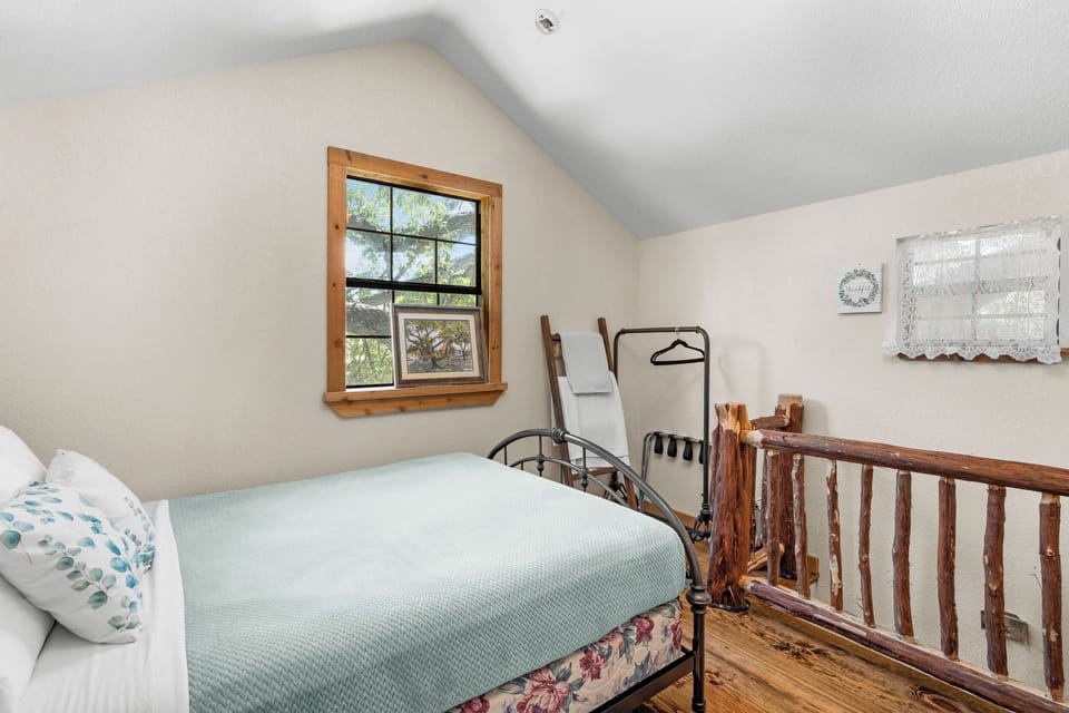 Rest peacefully in a cozy bedroom with a wooden bed frame and soft blue bedding.
