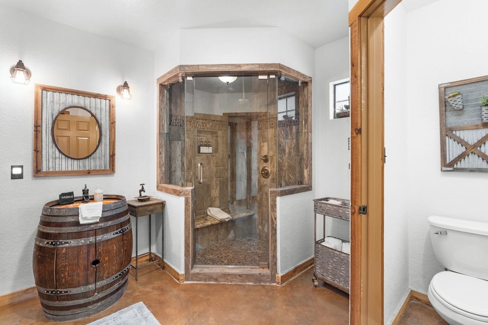 Wash off a day in Fredericksburg in the barn bathroom, with a walk-in shower and a distinctive barrel-style vanity.