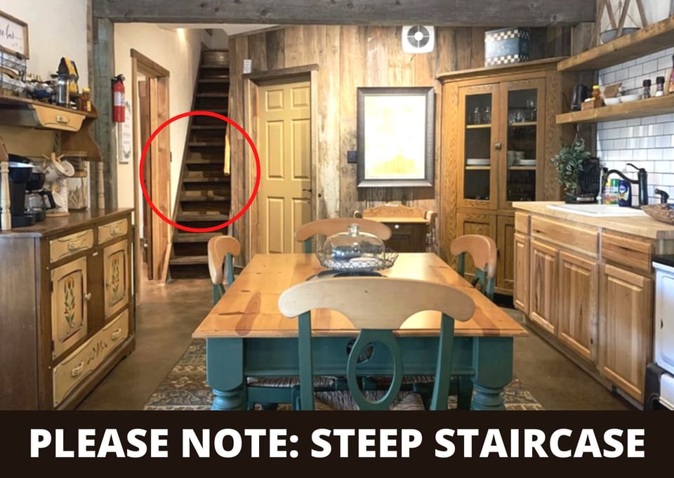 Our charming cottage features a steep, ladder-style staircase leading up to the second-floor loft area. Guests appreciate this heads-up, as it's part of the home's authentic, space-saving rustic design.