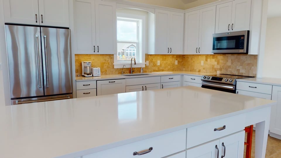 Island in kitchen with comfortable seating.