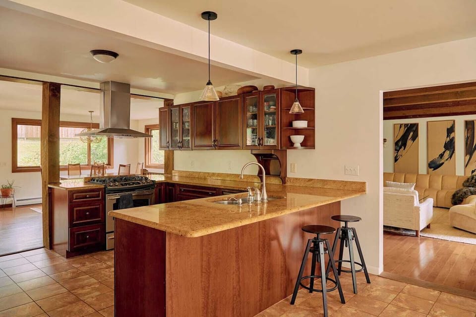 Kitchen // Open floor plan- kitchen, (2) breakfast bars, and dining room. Kitchen stocked with anything you might need for cooking up a feast. 