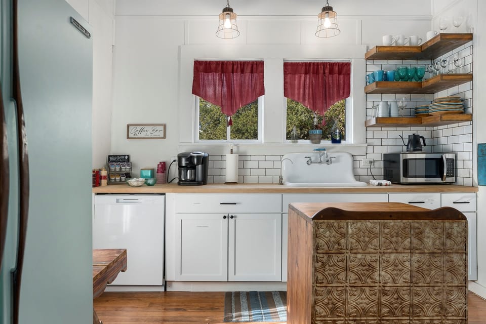 This bright farmhouse inspired kitchen blends rustic charm with modern convenience, ideal for extended stays in Fredericksburg.