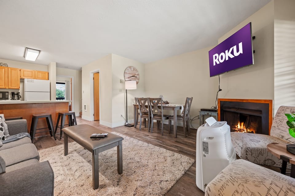 The open-concept living space, complete with a dining area, facilitates effortless conversation with family and friends.