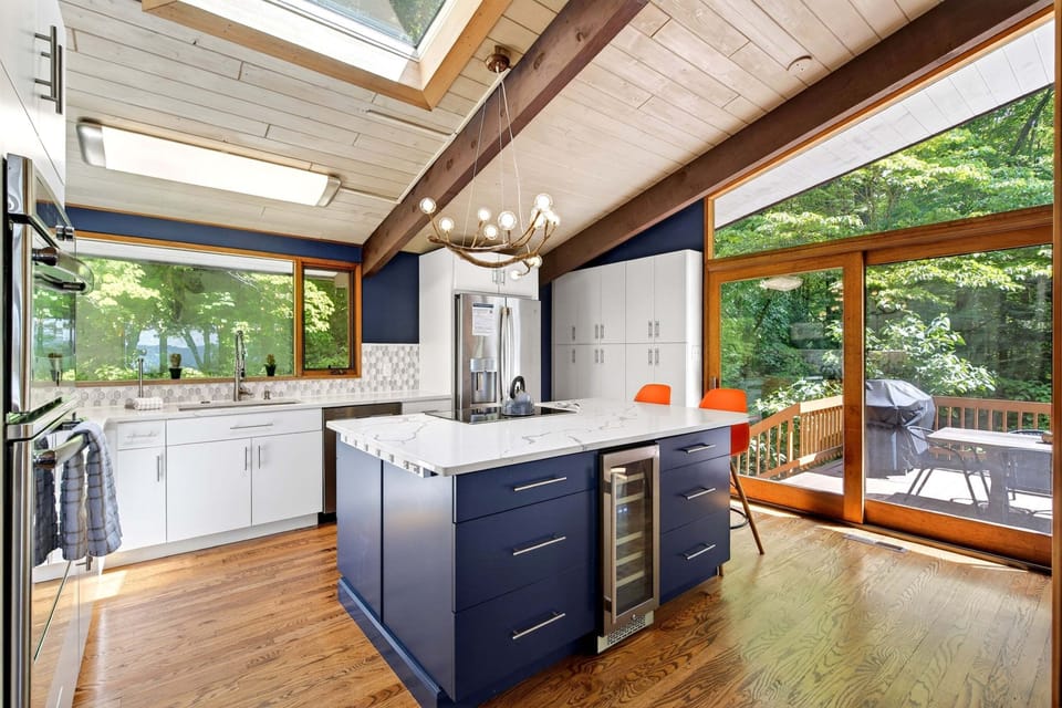 The gourmet GE kitchen with a vaulted ceiling & skylight is perfect for morning waffles, Vitamix smoothies, and every meal in between