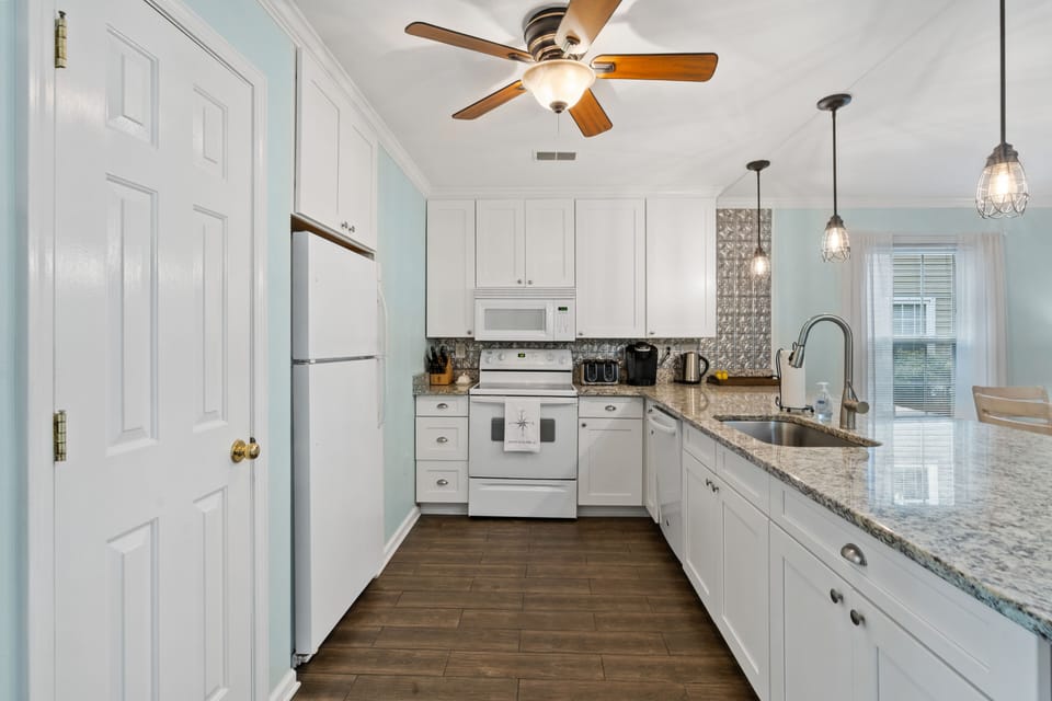 fully stocked kitchen with granite countertops