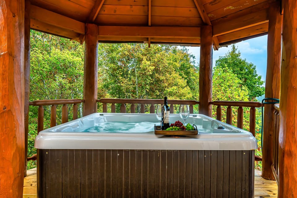 Covered hot tub has mountain views and is directly off the main living space