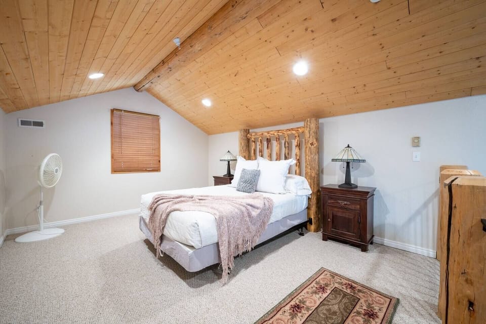 The second bedroom is located in the loft, and outfitted with a queen bed, luxurious linens, and plush pillows.