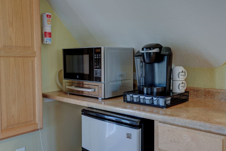 Microwave/Toaster, Coffee, Fridge, Ironing Board, Induction Stovetop.