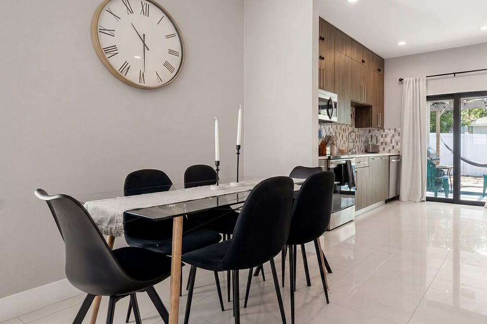 The dining table with the kitchen on one side and the patio on the other.
