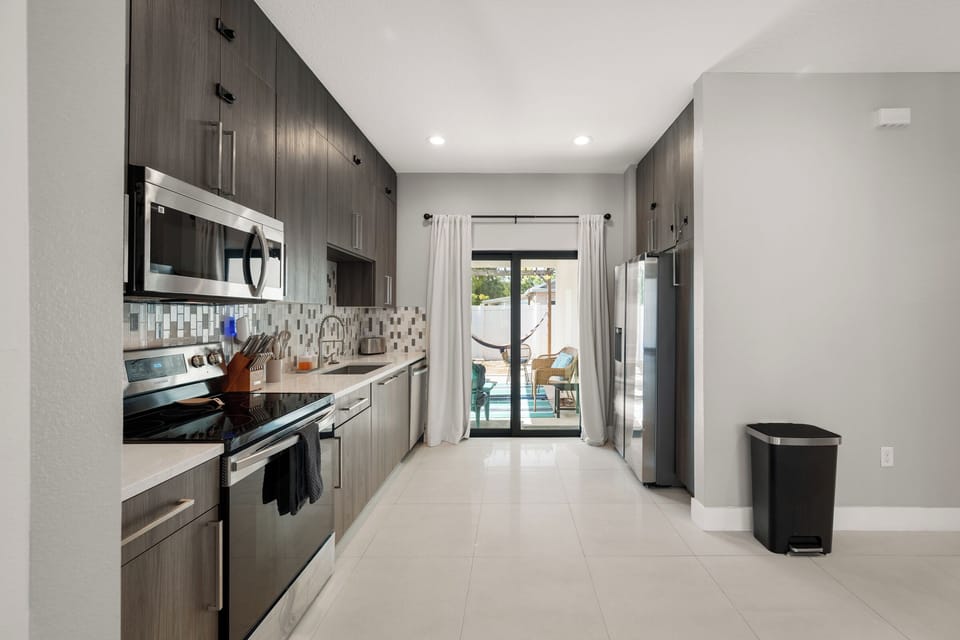 A galley kitchen that opens straight to the patio so cooking stays connected
