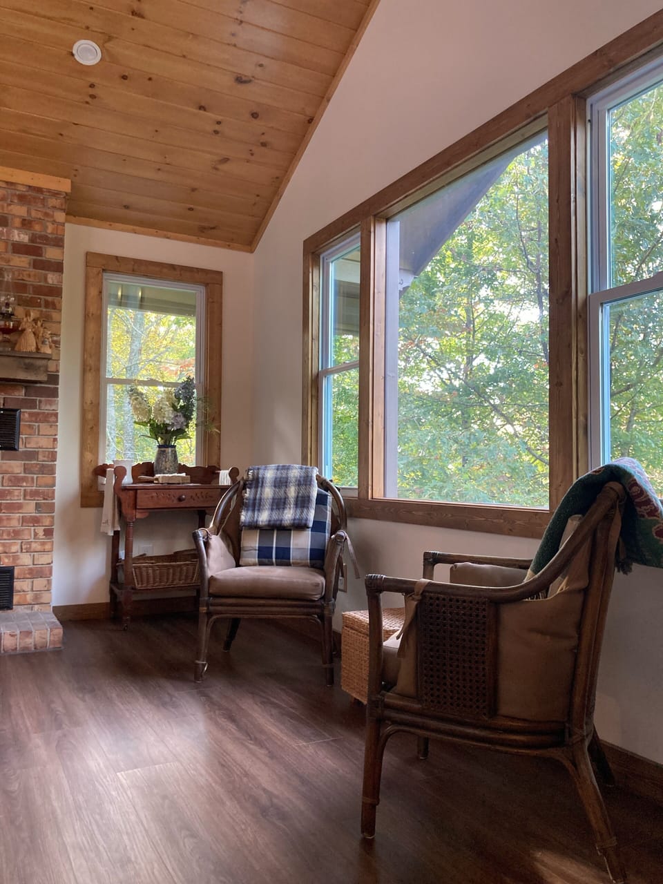 Sitting area in dining room, surrounded by trees, perfect for morning coffee