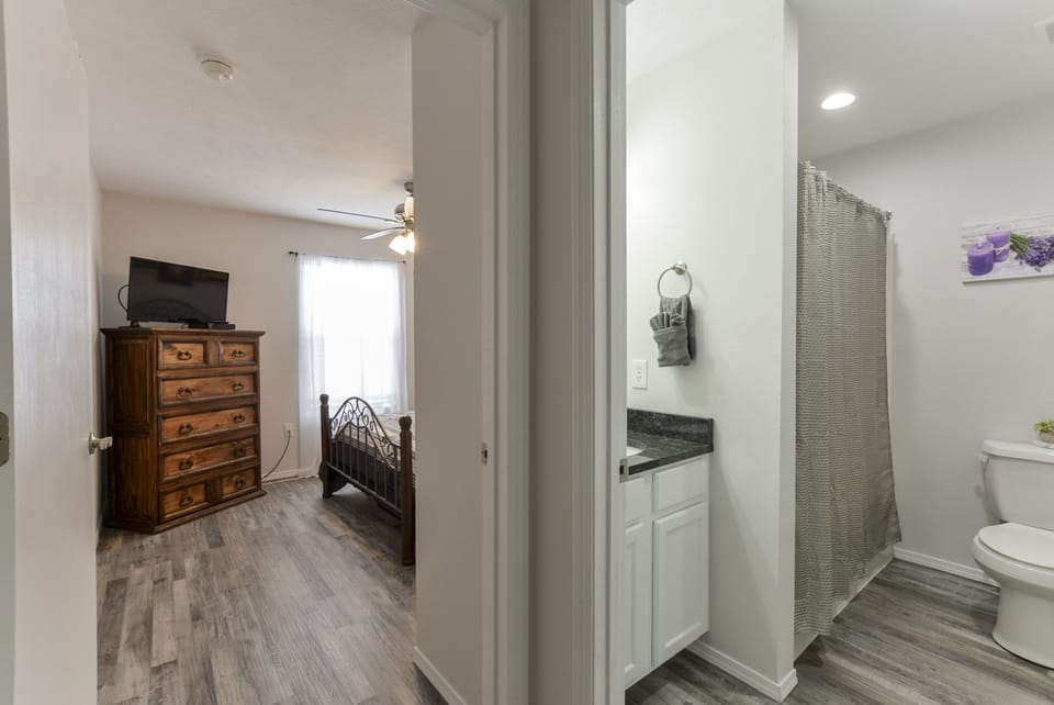 View of second bathroom and into the 3rd queen bedroom