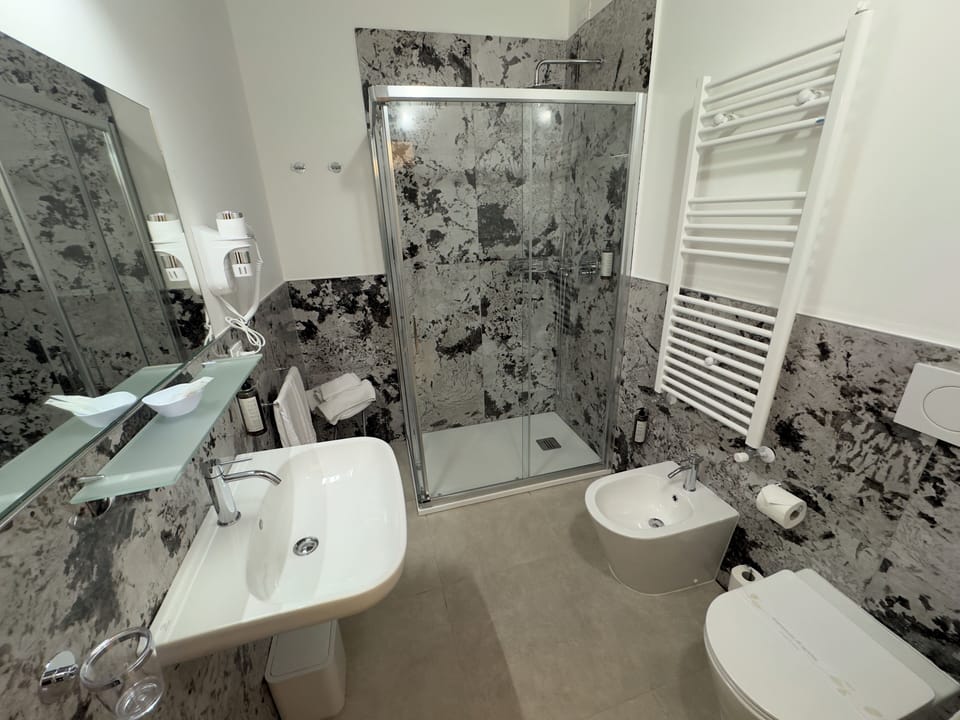 Shower, rainfall showerhead, hair dryer, towels
