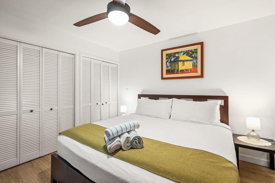King bed, ceiling fan, and closet space enough to unpack and forget the suitcase exists.