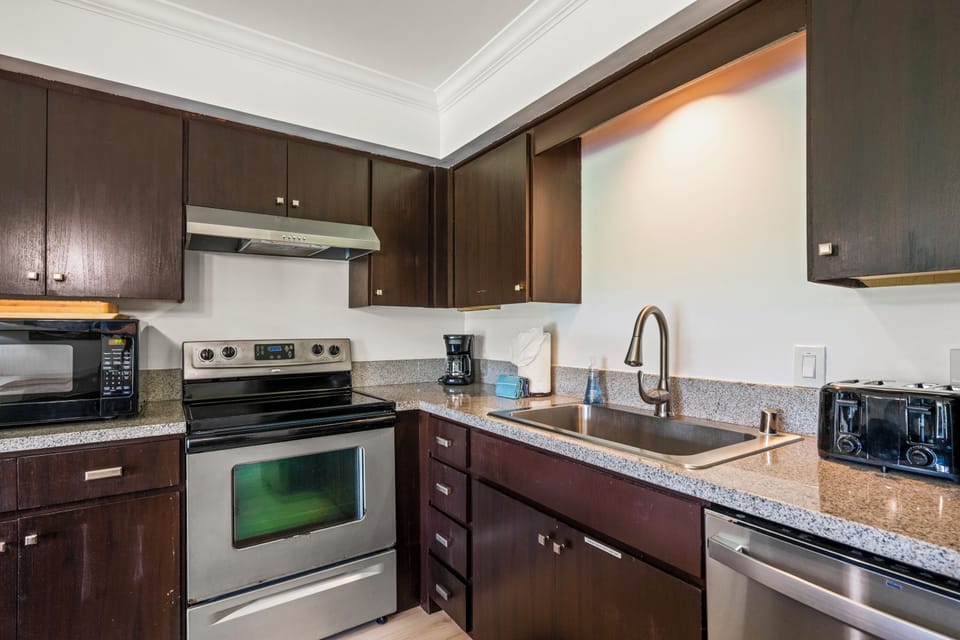 Stainless range, oven, and dishwasher mean a real meal comes together easily with kitchen tools right at hand and modern appliances.