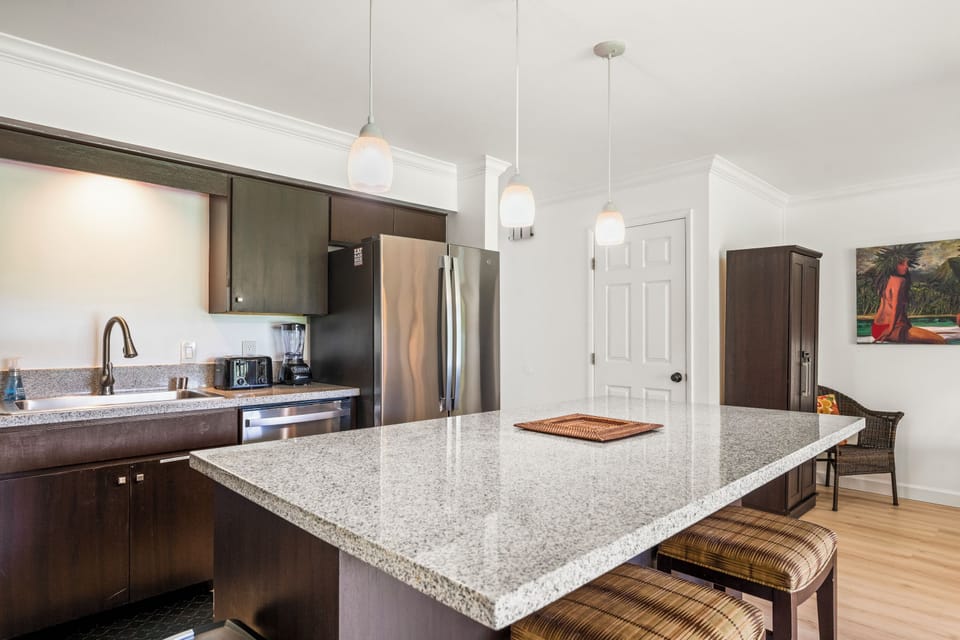 Cushioned bar stools at the island offer a casual gathering space near the kitchen
