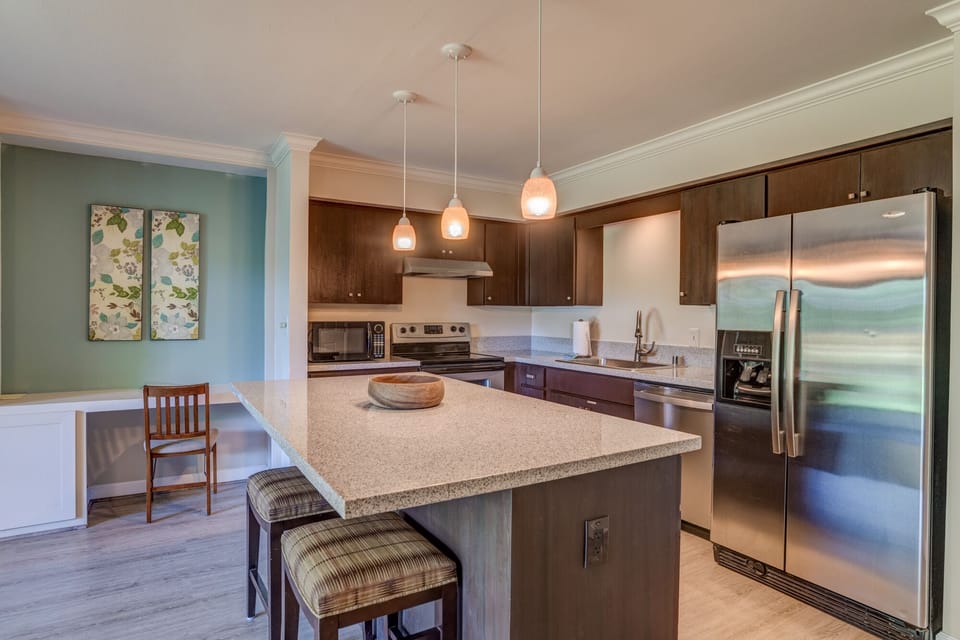 Modern chef-ready kitchen with granite countertops and a central island for easy meal prep or morning coffee.