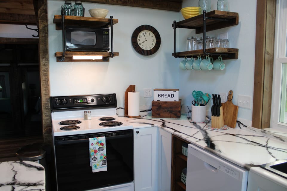 A second view of the kitchen with  dishwasher, range and refrigerator included.