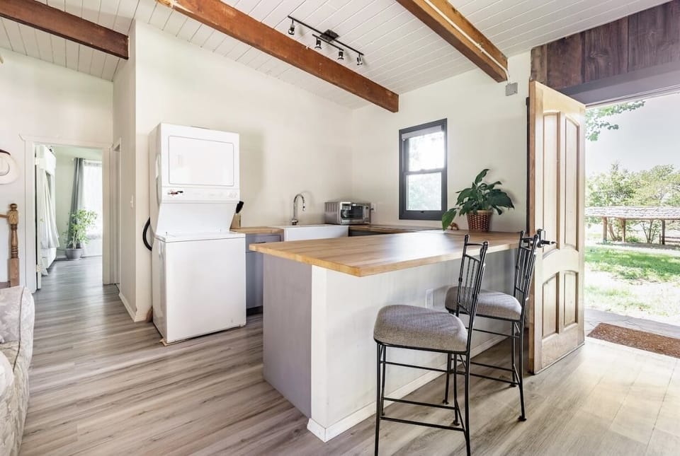 kitchenette with back door looking out to the green meadows and private river 