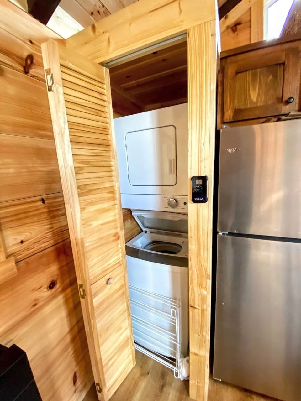 Washer and dryer are adjacent to the kitchen area.