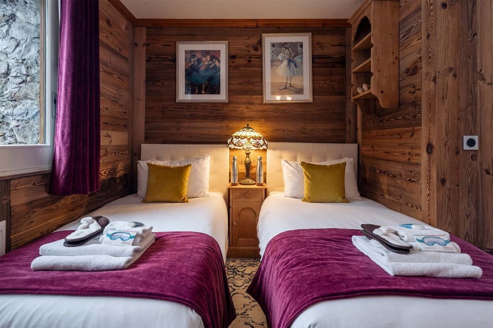 Beds made up with care — towels and decorative pillows included
