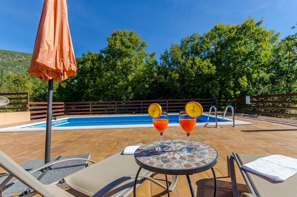 Outdoor pool, a heated pool, open open 24 hours, pool umbrellas