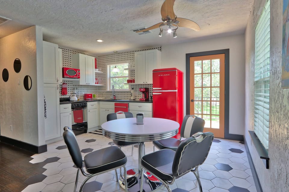 Full kitchen with refrigerator, dishwasher, microwave, oven, and coffee maker
