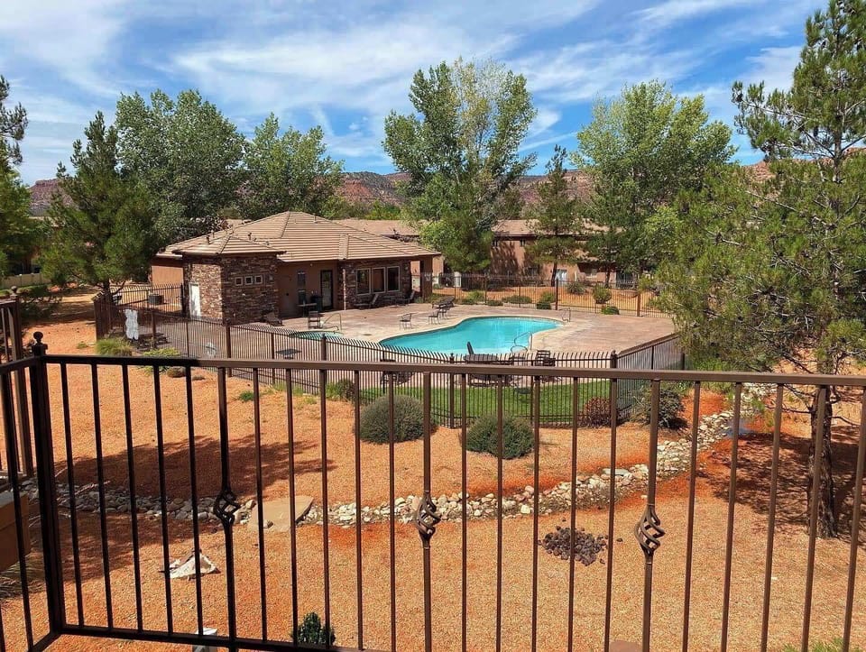 Balcony views of the sparkling community pool framed by Kanab's iconic red rock scenery.