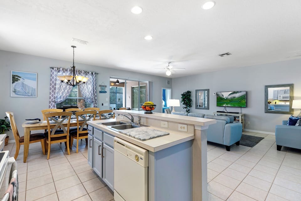 Bright and modern kitchen with every appliance needed, including large fridge freezer with ice maker, dishwasher, cooker, microwave, air fryer and coffee maker.