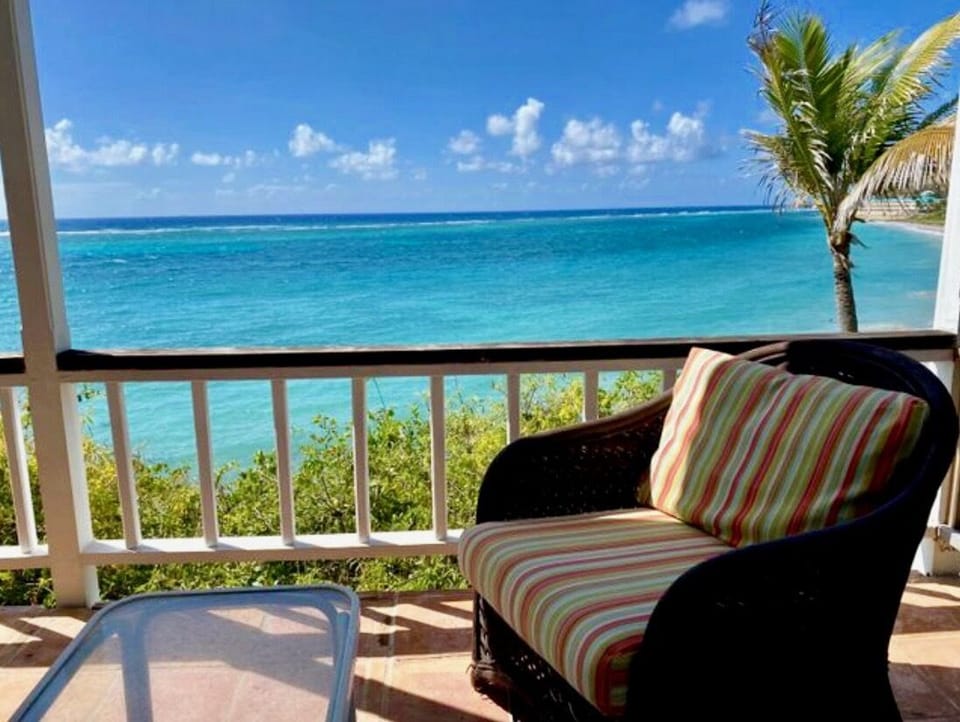 Relax on the deck just steps from the crystal blue Caribbean Sea