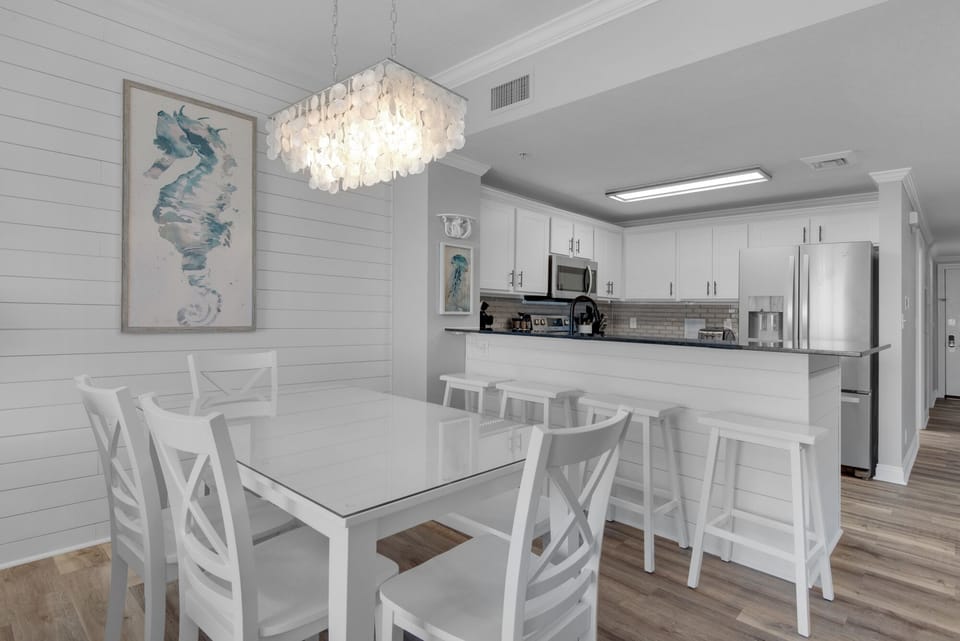 Dining Area - Create lasting memories around this chic dining table for four, plus 4 chairs at the kitchen bar, where home-cooked meals and beautiful beach vistas go hand in hand.