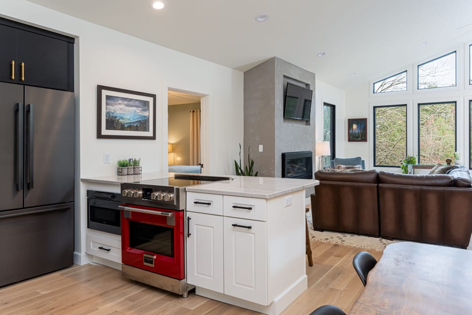 Sleek kitchen with breakfast bar seating for 4, a dishwasher & standard drip coffeemaker.