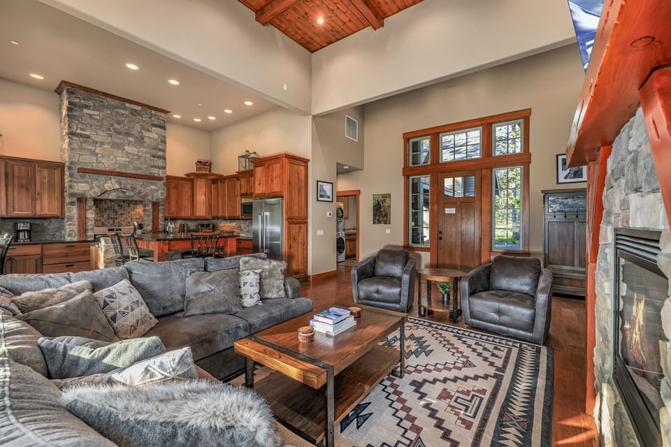 Large sectional sofa beneath vaulted ceilings, accented by wooden beams