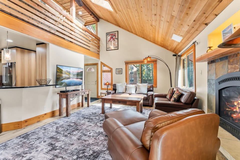 Living Room 1: Gas fireplace, comfortable seating, flat-screen TV