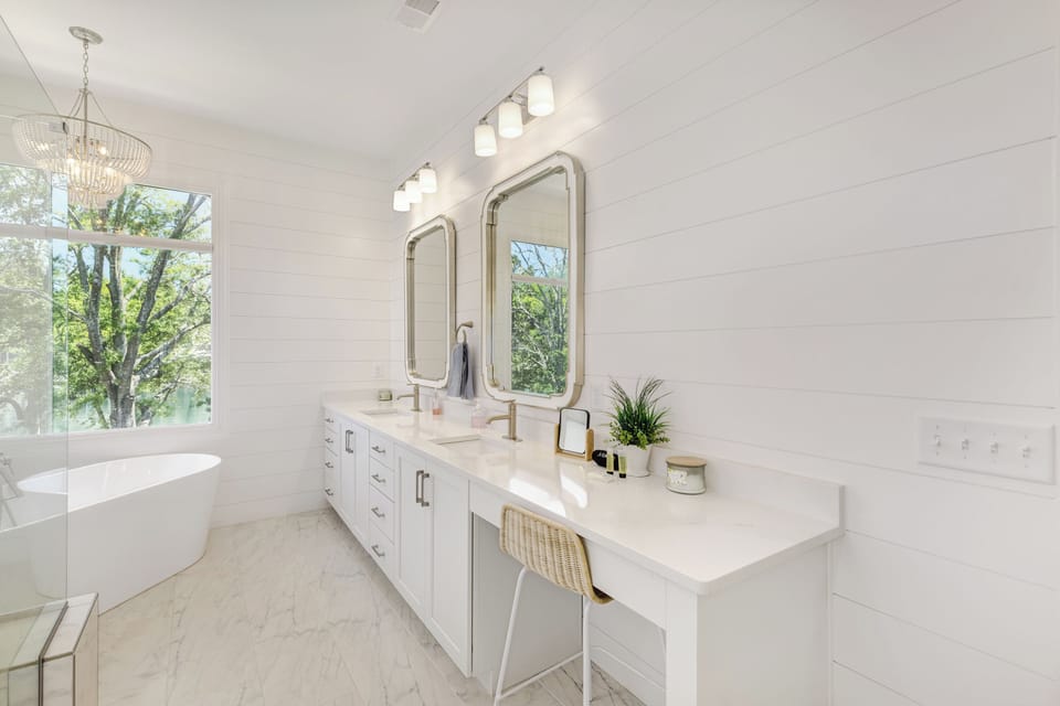 Hotel quality bathroom with dual vanity, quartz, marble shower, separate tub.