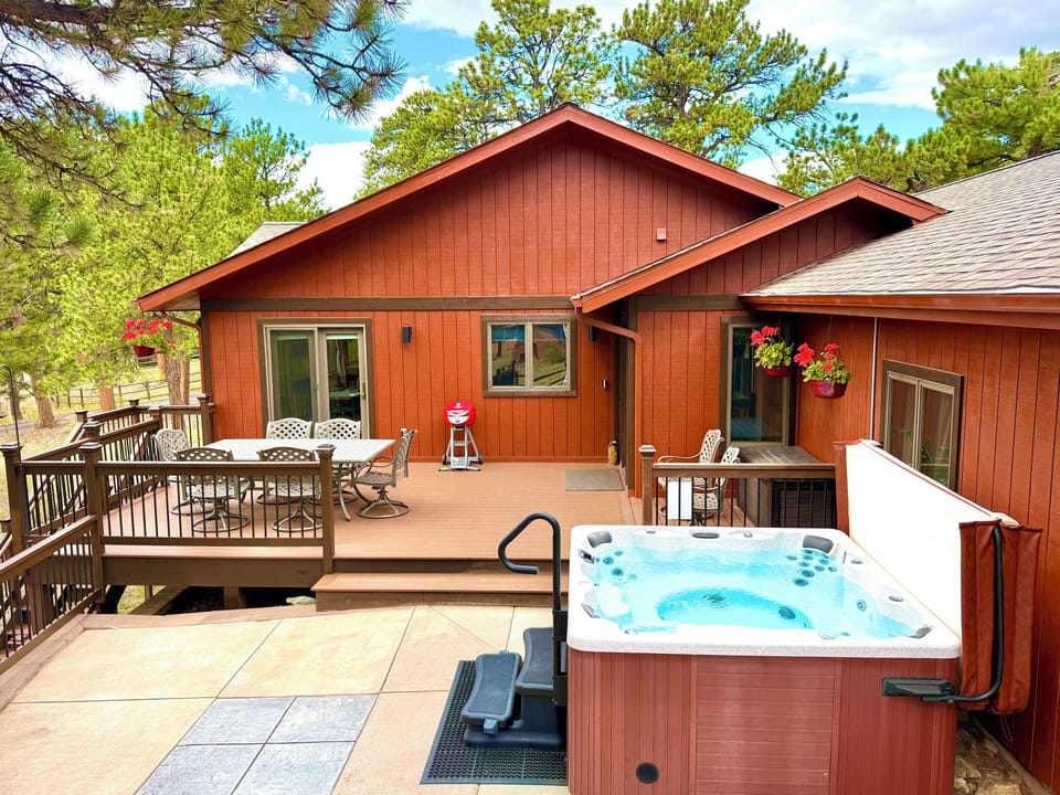 Front Entrance to House with Outdoor Dining Area and 6 Person Hot Tub