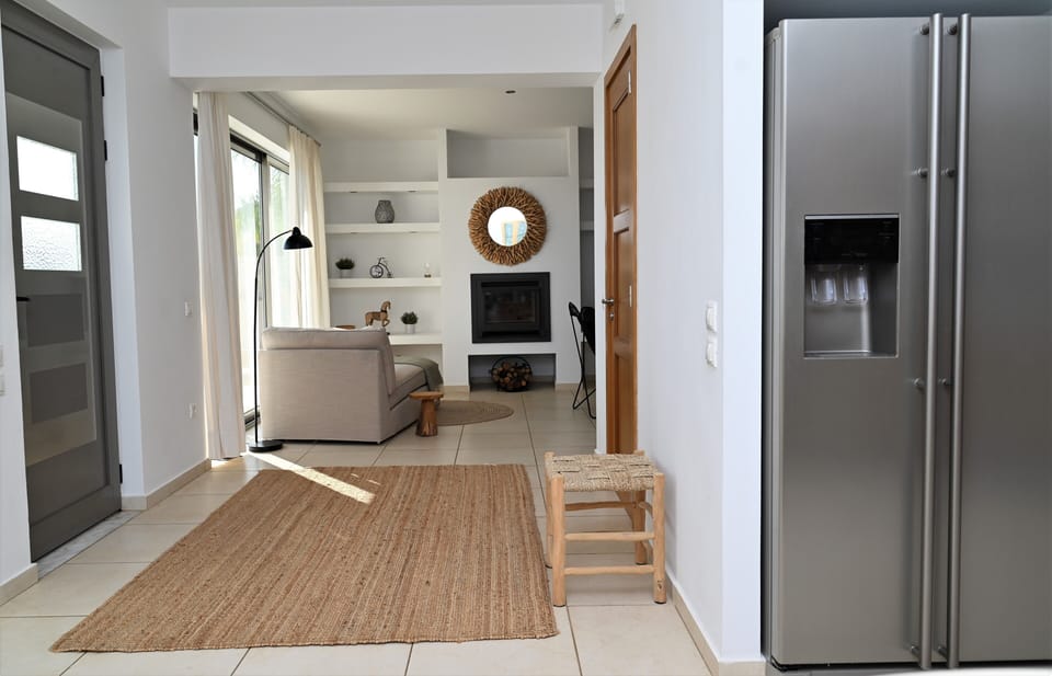 Main Entrance Hallway with Coat Closet Between Living Room and Dining Area 