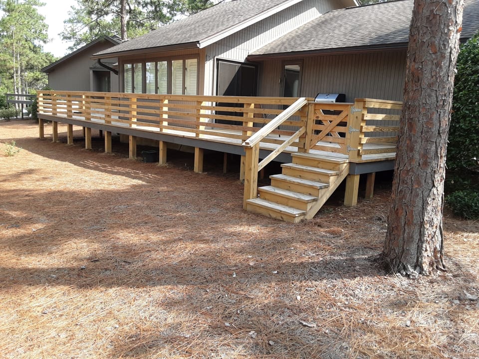 back of house with new deck
