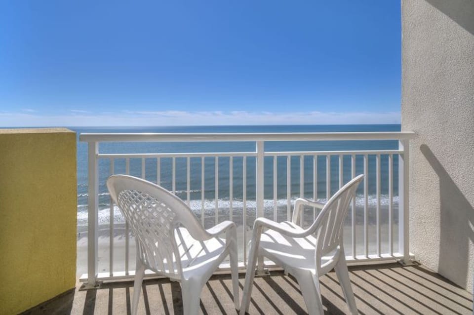 Sit outside and relax on this ocean view balcony and listen to the waves.