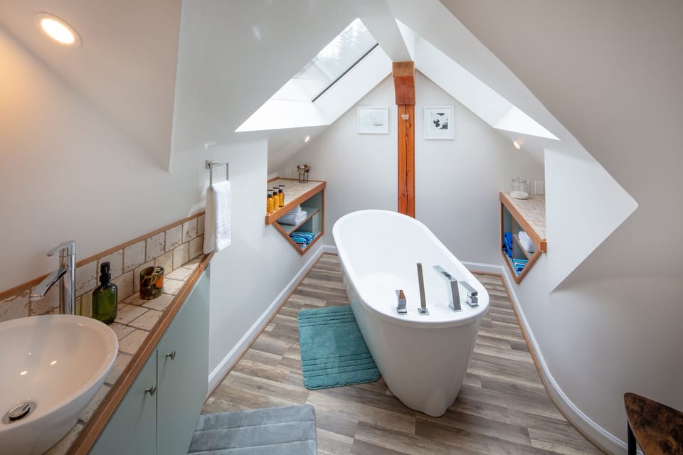Bathroom with Tub under 2 Skylights